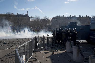 French police use tear gas to disperse protesters against pension reform in Paris | French police use tear gas to disperse protesters against pension reform in Paris