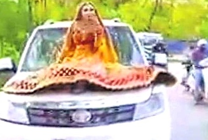 Bride rides on car bonnet, gets fined by UP cops | Bride rides on car bonnet, gets fined by UP cops