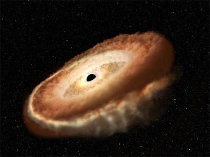 Hubble finds hungry black hole twisting captured star into donut shape | Hubble finds hungry black hole twisting captured star into donut shape