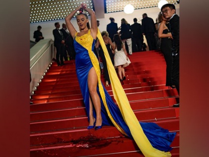 Woman draped in 'Ukrainian colours' pours fake blood on herself at Cannes red carpet | Woman draped in 'Ukrainian colours' pours fake blood on herself at Cannes red carpet