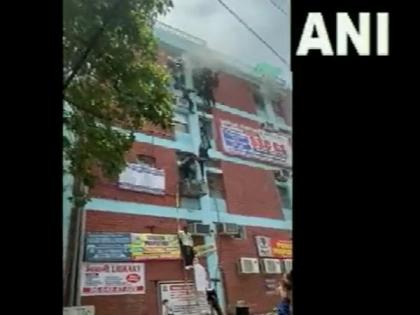 Fire breaks out at building in Delhi's Mukherjee Nagar, people rappel down for safety | Fire breaks out at building in Delhi's Mukherjee Nagar, people rappel down for safety