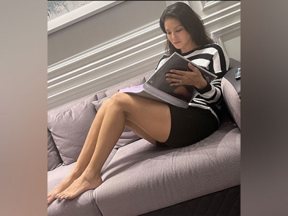 Sunny Leone gears up for next project as she poses with mammoth "huge script" | Sunny Leone gears up for next project as she poses with mammoth "huge script"