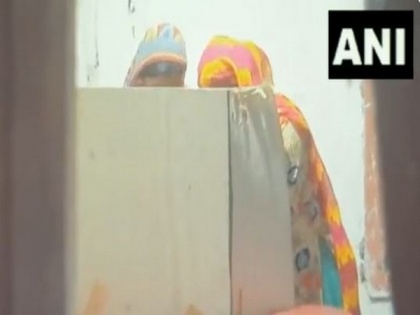 WB: In viral clip, woman purportedly seen helping voter inside polling booth | WB: In viral clip, woman purportedly seen helping voter inside polling booth