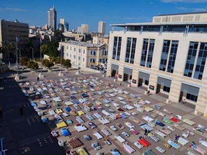Members of Kibbutz Nir Oz in Jerusalem set up 239 empty beds, symbolizing Israeli hostages | Members of Kibbutz Nir Oz in Jerusalem set up 239 empty beds, symbolizing Israeli hostages Members of Kibbutz Nir Oz in Jerusalem set up 239 empty beds, symbolizing Israeli hostages | Members of Kibbutz Nir Oz in Jerusalem set up 239 empty beds, symbolizing Israeli hostages