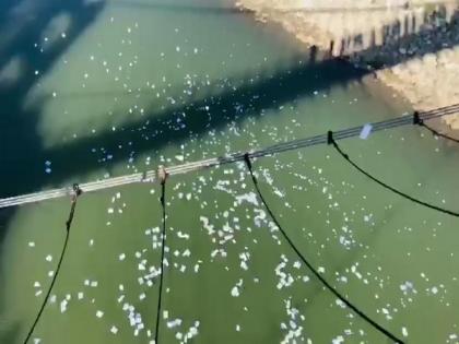 PoK: Residents protest soaring electricity bills by symbolically throwing power bills in river | PoK: Residents protest soaring electricity bills by symbolically throwing power bills in river