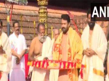 Mohanlal receives Vilambara Pathrika from Travancore royal family members | Mohanlal receives Vilambara Pathrika from Travancore royal family members