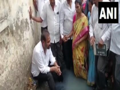 YSRCP MLA enters open drain as mark of protest against civic authorities | YSRCP MLA enters open drain as mark of protest against civic authorities