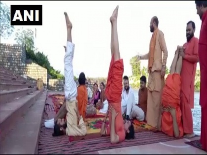 Saints in Haridwar practice Yoga on banks of Ganga ahead of International Day of Yoga | Saints in Haridwar practice Yoga on banks of Ganga ahead of International Day of Yoga