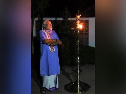 PM Modi lights lamp, leads citizens in expression of collective resolve to fight COVID-19 | PM Modi lights lamp, leads citizens in expression of collective resolve to fight COVID-19