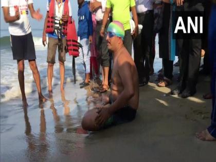 Karnataka man swims in Yoga posture with chained legs, attempts record | Karnataka man swims in Yoga posture with chained legs, attempts record