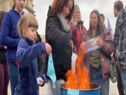 Protesters burn masks to protest against COVID-19 safety guidelines outside Idaho state Capitol in US | Protesters burn masks to protest against COVID-19 safety guidelines outside Idaho state Capitol in US