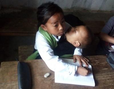 Manipur: 10-yr-old girl attends classes with sister in lap | Manipur: 10-yr-old girl attends classes with sister in lap