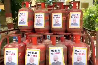 TRS hits back at FM with PM's pictures on LPG cylinders | TRS hits back at FM with PM's pictures on LPG cylinders
