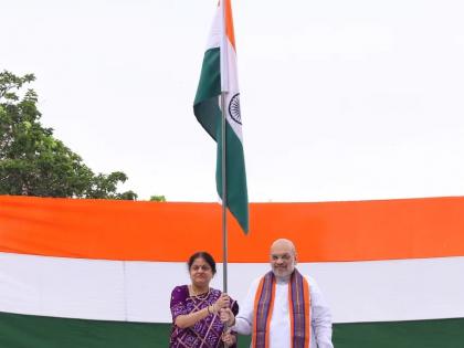 Amit Shah hoists Tricolour at his residence | Amit Shah hoists Tricolour at his residence