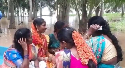 Andhra bride in flood-hit village takes boat to reach for wedding | Andhra bride in flood-hit village takes boat to reach for wedding Andhra bride in flood-hit village takes boat to reach for wedding | Andhra bride in flood-hit village takes boat to reach for wedding