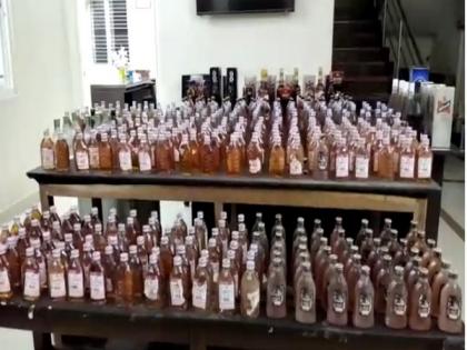 2 constables caught for illegally transporting liquor in Andhra's Krishna | 2 constables caught for illegally transporting liquor in Andhra's Krishna