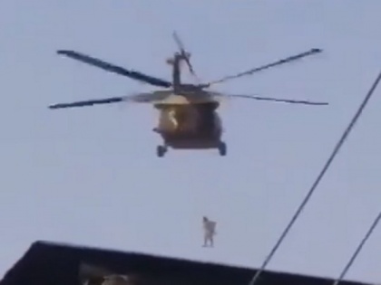 Afghan journalists say man seen hanging from helicopter a flag installer, wasn't dead | Afghan journalists say man seen hanging from helicopter a flag installer, wasn't dead