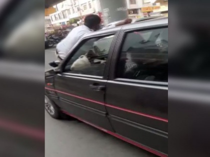 Pune: Man drags traffic cop on car bonnet, arrested | Pune: Man drags traffic cop on car bonnet, arrested