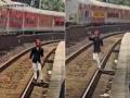 Viral Video Shocks Mumbai: Man Seen ‘Aura Farming’ on Local Train Tracks, Passengers Pull Him to Safety in Bhayander - Hindi News | Viral Video Shocks Mumbai: Man Seen ‘Aura Farming’ on Local Train Tracks, Passengers Pull Him to Safety in Bhayander | Latest mumbai News at Lokmattimes.com