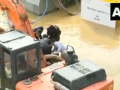 Watch! Man gets stuck on a waterlogged road during heavy rains in Bengaluru - Hindi News | Watch! Man gets stuck on a waterlogged road during heavy rains in Bengaluru | Latest national News at Lokmattimes.com