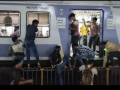 Mumbai Viral Video: Commuters Sit on Railings Between Tracks to Catch Train Amid Rush | Latest mumbai News at www.lokmattimes.com