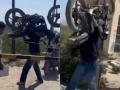 Man Ignores Railway Crossing Barrier, Lifts Bike on Shoulders to Cross Tracks (Watch Video) - Hindi News | Man Ignores Railway Crossing Barrier, Lifts Bike on Shoulders to Cross Tracks (Watch Video) | Latest social-viral News at Lokmattimes.com