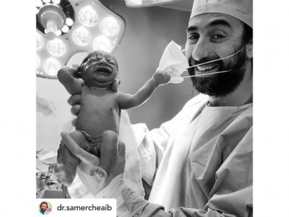 VIRAL PIC! Picture of newborn baby 'removing' doctor's mask goes viral, netizens say covid-19 pandemic to end soon | VIRAL PIC! Picture of newborn baby 'removing' doctor's mask goes viral, netizens say covid-19 pandemic to end soon