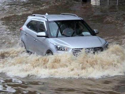 Thane: Car trapped on edge of swollen drain amidst heavy rainfall, two rescued unharmed | Thane: Car trapped on edge of swollen drain amidst heavy rainfall, two rescued unharmed Thane: Car trapped on edge of swollen drain amidst heavy rainfall, two rescued unharmed | Thane: Car trapped on edge of swollen drain amidst heavy rainfall, two rescued unharmed