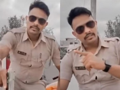 Khaki uniform, gun in hand; Cop who made filmy dialogue video suspended | Khaki uniform, gun in hand; Cop who made filmy dialogue video suspended