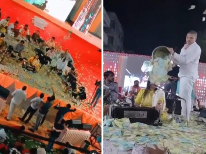 Money Rain VIDEO! Fans pour drum full of currency notes on Urvashi Radadiya during her performance | Money Rain VIDEO! Fans pour drum full of currency notes on Urvashi Radadiya during her performance