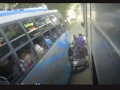 Couple on two wheeler gets caught between 2 buses, suffer minor injuries | Couple on two wheeler gets caught between 2 buses, suffer minor injuries