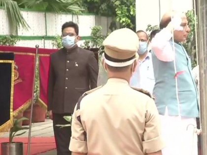 Defence Minister Rajnath Singh unfurls the national flag at his residence | Defence Minister Rajnath Singh unfurls the national flag at his residence