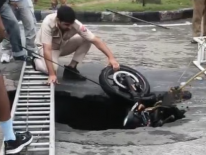 Chandigarh: Biker Falls Into Pit As Road Caves In After Heavy Rain; Video Goes Viral | Chandigarh: Biker Falls Into Pit As Road Caves In After Heavy Rain; Video Goes Viral