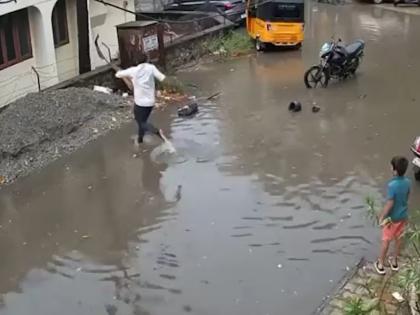 Chennai: Man Saves Schoolboy from Electrocution in Waterlogged Street; Video Goes Viral | Chennai: Man Saves Schoolboy from Electrocution in Waterlogged Street; Video Goes Viral