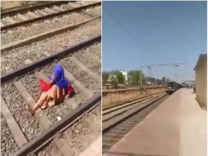 Viral Video: Train passes over girl's body while she tallks on phone | Viral Video: Train passes over girl's body while she tallks on phone Viral Video: Train passes over girl's body while she tallks on phone | Viral Video: Train passes over girl's body while she tallks on phone