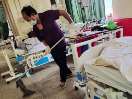 COVID-19 positive Mizoram minister seen mopping hospital floor, pic goes viral | COVID-19 positive Mizoram minister seen mopping hospital floor, pic goes viral