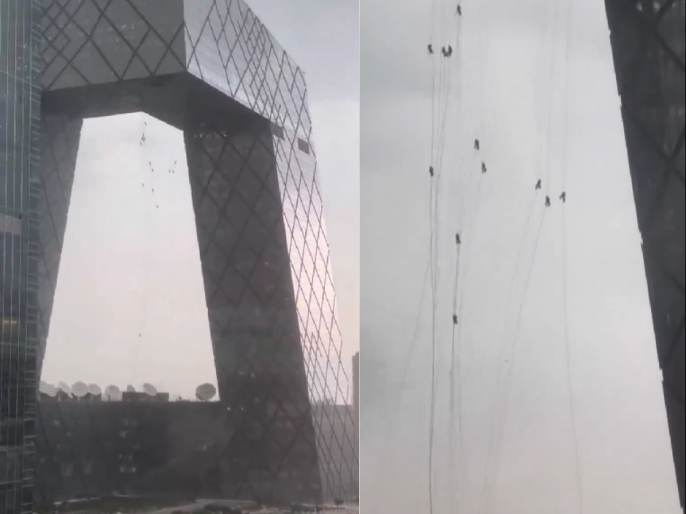 China: Glass Maintenance Workers Trapped Hanging From Building in ...