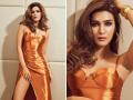 Kriti Sanon : बॉडीकॉन गाउनमध्ये क्रितीचं सिझलिंग फोटोशूट, फोटो व्हायरल - Marathi News | Kriti Sanon flaunts toned legs in orange slit dress see photos | Latest filmy Photos at Lokmat.com