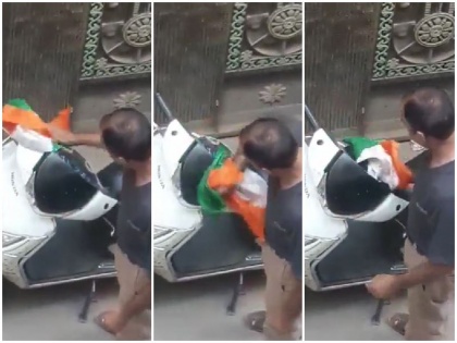 bhajanpura man cleaning sweeping scooty with tiranga delhi police took action video viral | Video: तिरंगे से धूल झाड़ते हुए स्कूटी साफ कर रहा था युवक, वीडियो वायरल पर पुलिस ने लिया एक्शन