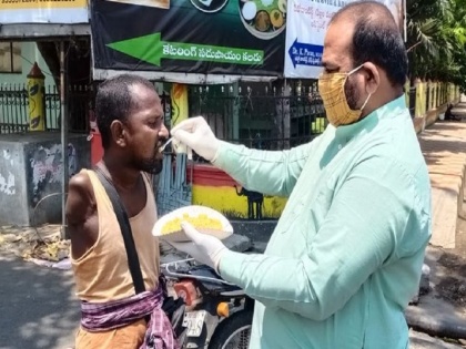 Andhra Pradesh BJP leader feed handicapped man during Lockdown viral | विकलांग को खाना खिलाते बीजेपी नेता की तस्वीर वायरल, संबित पात्रा ने भी ट्वीट कर किया अभिनंदन