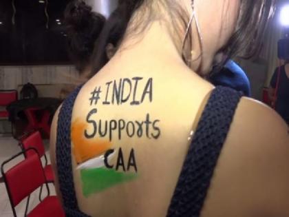 Models celebrating New Year by writing 'India Support CAA' on body in Vadodara Gujarat | वड़ोदरा: नये साल के जश्न में भी छाया रहा CAA का मुद्दा, कई मॉडल्स ने कानून के समर्थन में टैटू बनाकर मनाया जश्न
