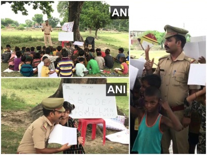 meet sub inspector ranjeet yadav teach ayodhya district poor child under open up police uniform see photos | UP: मिलिए सब इंस्पेक्टर रणजीत से जो अयोध्या के गरीब बच्चों को फ्री में दे रहा है शिक्षा, पुलिस ड्रेस में खुले आसमान के नीचे ऐसे पढ़ाता है अधिकारी, देखें फोटो