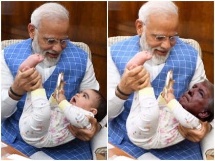 pm modi shares photo with playing kid social media memes on donald trump and rahul gandhi | पीएम मोदी की गोद में खेलते हुये बच्चे की तस्वीर वायरल, लोगों ने डोनाल्ड ट्रंप और राहुल गांधी पर ली चुटकी
