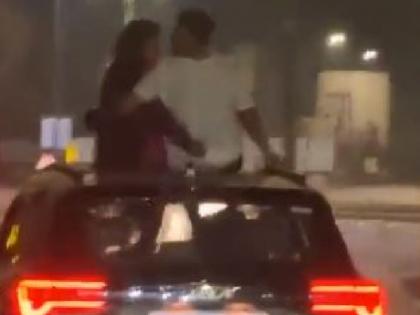 Couple kissed each other repeatedly on top of a moving car Viral Video on social media | Viral Video: चलती कार के ऊपर कपल ने एक-दूसरे को किया बार-बार 'किस', अब यूजर्स कर रहे सोशल मीडिया पर ऐसे कमेंट्स....