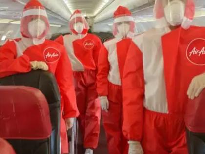 AirAsia unveils red PPE suits for cabin crew | लॉकडाउन खुलने के बाद फ्लाइट भरेंगी उड़ान, देखने को मिली एय़र एशिया की तैयारी, केबिन क्रू पहनेंगे ये खास ड्रेस