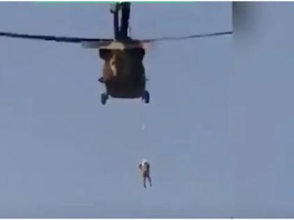 Afghanistan: Taliban fly American chopper with man hanging from rope watch this viral Video | Afghanistan: तालिबान की नई करतूत, अमेरिकी हेलीकॉप्टर पर शख्स को बांधा, लटकाया फिर उड़ाया, देखें ये खौफनाक वीडियो