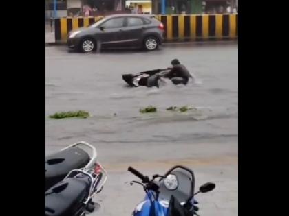 Pune Rains Young man seen drowning to handle the scooter floating on the road video of submerged roads goes viral | Pune Rains: बारिश से बेहाल पुणे... सड़क पर बहती स्कूटी संभालने के लिए डूबता दिखा युवक, जलमग्न सड़कों का वीडियो वायरल