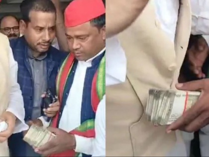 Lok Sabha Election 2024 Samajwadi party candidate give bribes to people for vote viral video | Lok Sabha Election 2024: सपा प्रत्याशी का 500 की गड्डी देते हुए वीडियो आया सामने, सफाई में कहा, "लोकतंत्र बचाने के लिए जनता ने किया"