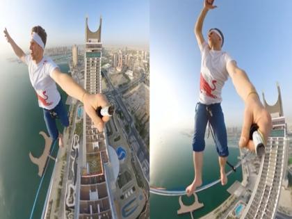 slackline athlete Jaan Roose walk rope on Qatar famous Katara Towers in Lusail Marina video | Video: रस्सियों के सहारे कतर के नामी टावर पर चलते दिखा स्लैकलाइन खिलाड़ी जान रूस, 185 मीटर की ऊंचाई से खौफनाक वीडियो आया सामने