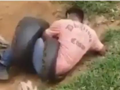 Video: Giant dragon snake wrapped in man's feet, 2 people tried to save | Video: शख्स के पैरों में लिपटा विशालकाय अजगर सांप, 2 लोगों ने किया बचाने का प्रयास Video: Giant dragon snake wrapped in man's feet, 2 people tried to save | Video: शख्स के पैरों में लिपटा विशालकाय अजगर सांप, 2 लोगों ने किया बचाने का प्रयास